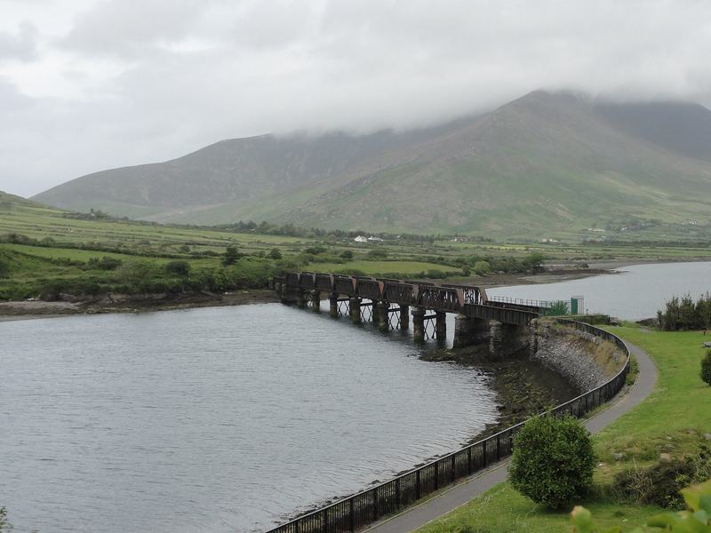 The old railway viaduct over the river at Cahersiveen, with a mountain in cloud behind